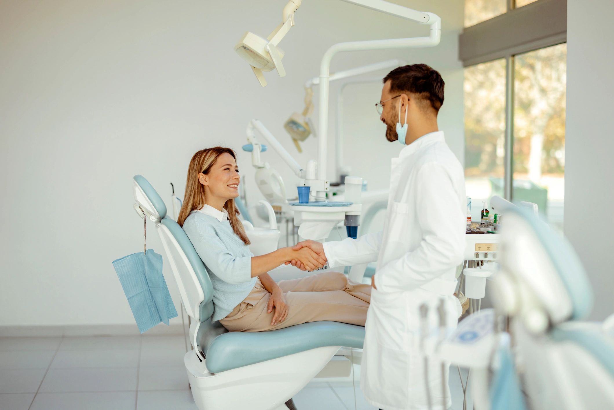 Patient greeting a dentist at a dental clinic