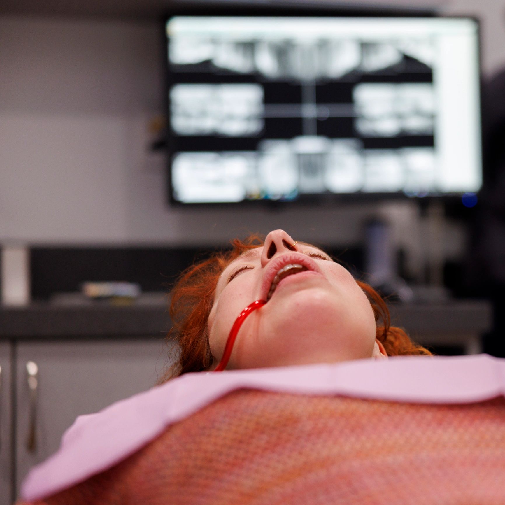 Patient relaxing in a dental chair during treatment